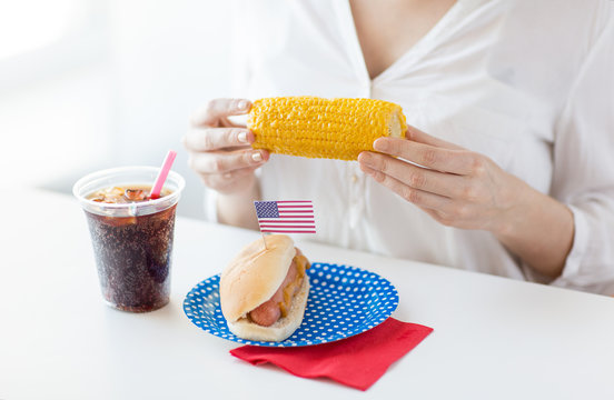 Woman Hands Holding Corn With Hot Dog And Cola