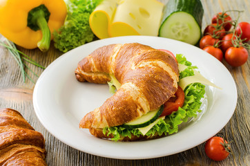 Croissant sandwich with cheese and vegetables for healthy snack