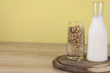 oatmeal flakes in a glassful next to the milk carafe. 
