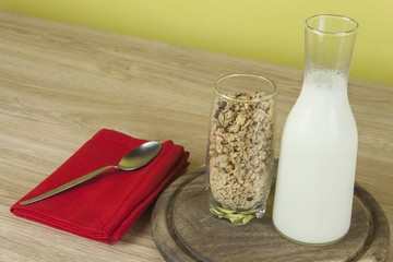 oatmeal flakes in a glassful next to the milk carafe. 
