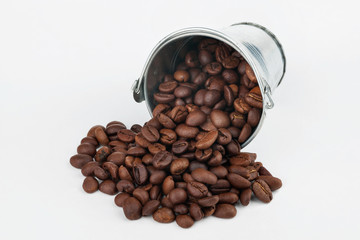 Coffee beans spilling out of bucket