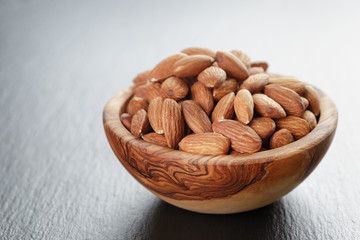 roasted almonds in bowl on slate background