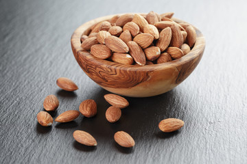 roasted almonds in bowl on slate background