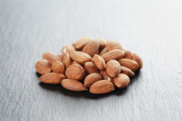 roasted almonds on slate background