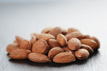 roasted almonds on slate background