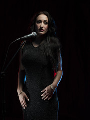 Fototapeta premium Beautiful female singer in studio