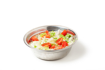 fresh salad in a metal plate on white