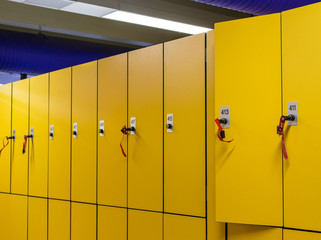 Colorful public lockers with keys in a swimming pool. Security concept.
