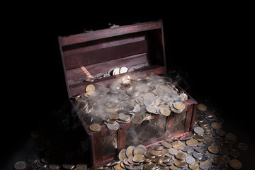 Treasure chest filled with coin baht and fog. It seems a mystery