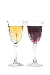 Red and white wine in luxurious crystal glasses isolated in white