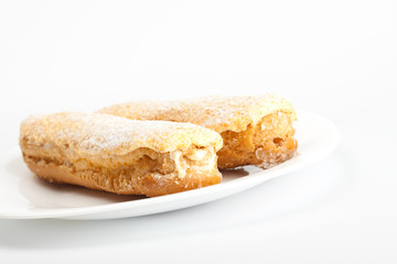 two eclairs on white dish