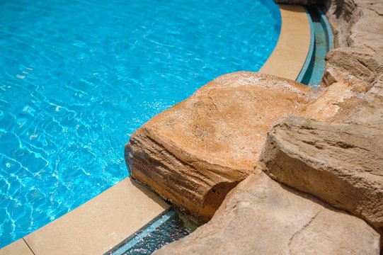 Corner of a swimming pool with decorative stones