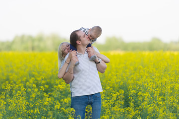 family from three people on a rape field