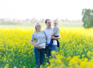 family from three people on a rape field