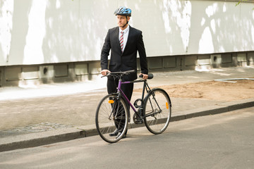 Male Cyclist With His Bicycle On Road