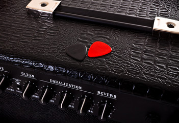 two plectrums on guitar amplifier