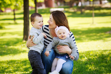 Family in park outside in summer. Mothers Day celebration concept