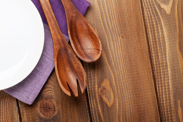 Wood kitchen utensils over wooden table