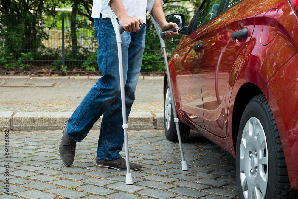 Wall mural Disabled Man With Crutches Walking Near Care