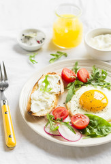 fried egg, vegetable salad and a grilled cheese sandwich 