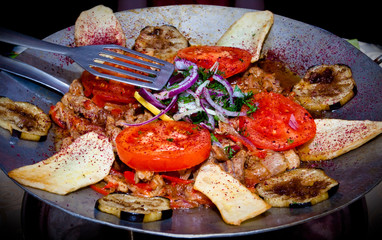metal dish with fried meat and vegetables