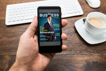 Person Hands With Mobile Phone Showing Business News