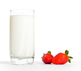 glass of milk and two strawberries
