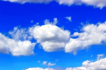 Bright Blue Sky with White Puffy Clouds.