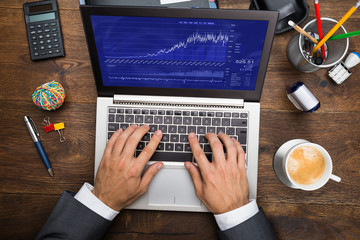 Businessman Analyzing Graph On Laptop