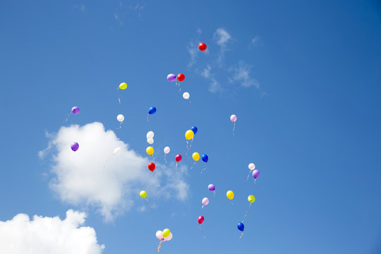 Flying colorful balls in the blue sky