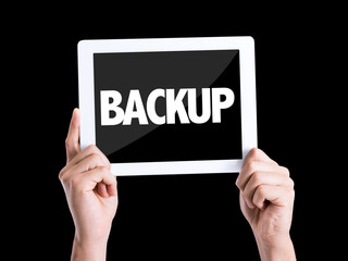 Tablet pc with text Backup isolated on black background