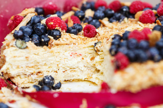 Closeup macro image of tasty delicious puff pastry cake with cream and fresh berries