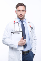 Thoughtful doctor holding papers 
