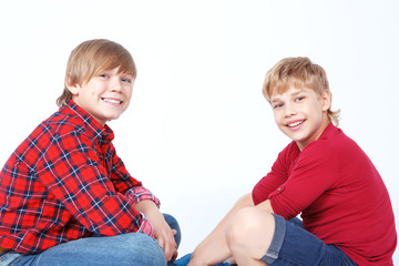 Smiling boys sitting on the floor 