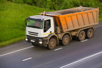 Fototapeta na wymiar dump truck goes on country highway