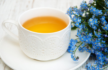 Cup of teand forget me not flowers