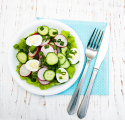 Spring salad with eggs, cucumbers and radish