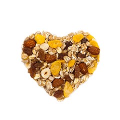 Cereal Muesli heart shaped on white background. Selective focus.