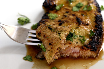 close-up piece of delicios tuna steak with greenery
