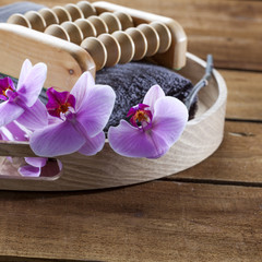 beauty ritual for spa treatment with natural sponge, towel, flowers and massage accessory
