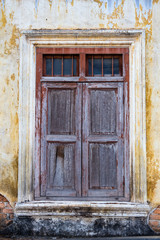 old wood window on the wall of a dilapidated old building