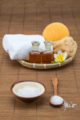 spa bath, salt bowl spoon, towel sponge essential oil and flower
