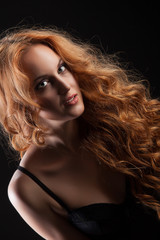 Naklejka premium Young Red- Haired Woman In Black Lingerie