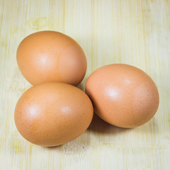 three eggs on wood background