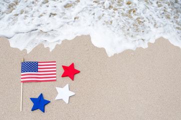 American flag with stars on the sandy beach