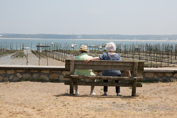 Couple sitting on the bench with their back to the camera