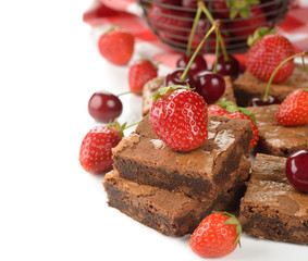 Chocolate brownies with strawberries and cherries