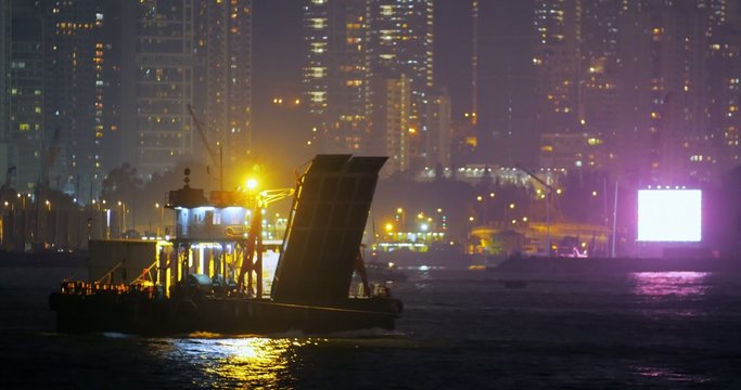 Night view of port harbor at night with cargo ships and boats float on water