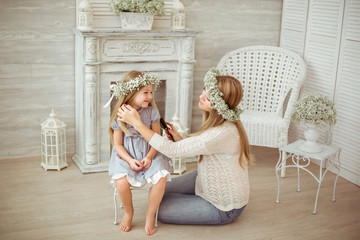 A happy mother is combing her daughter's hair - 84980695