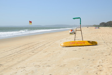 Beach Surf Rescue surfboard, flag and chair.